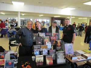 Dale T. Phillips, Stacey Longo, T.T. Zuma, and Mark Wholley behind the Books and Boos tables.